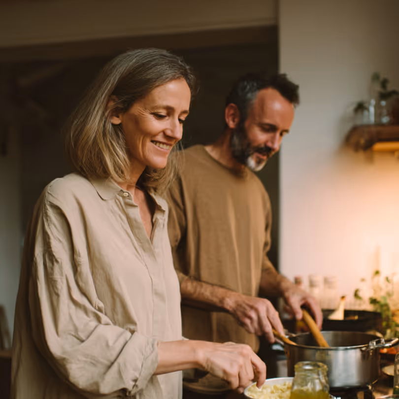 A couple talking together in their kitchen.